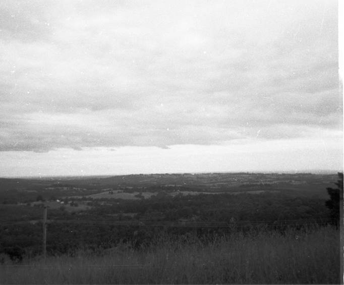 A black and white photo of a dry grass field

Description automatically generated
